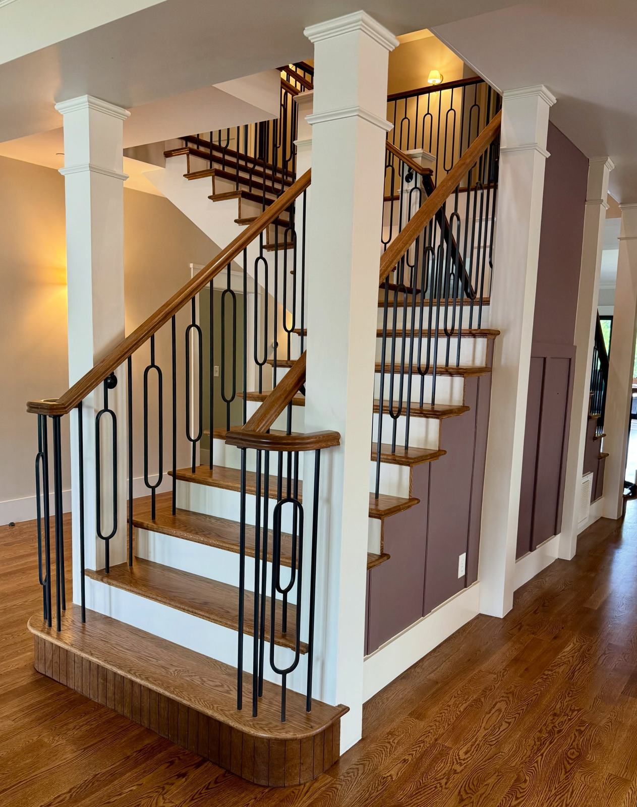 Staircase with stained treads and iron balusters