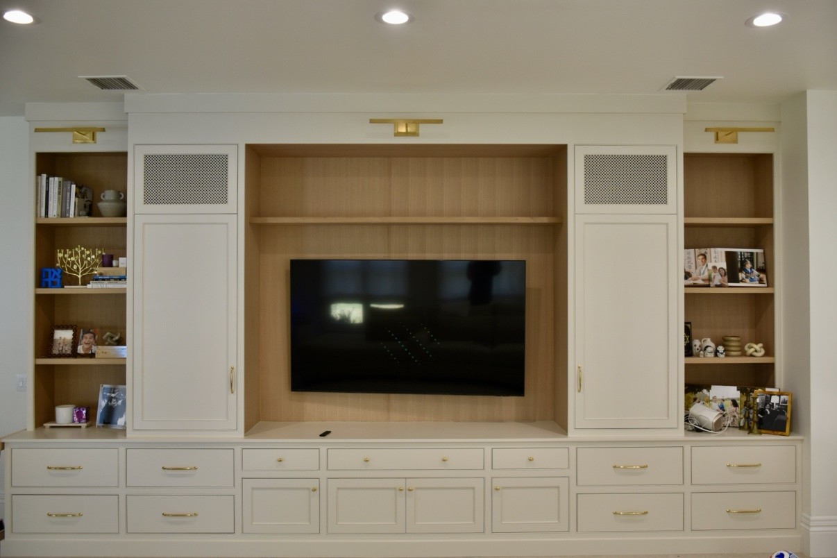 Entertainment wall after remodel, white built-in cabinetry
