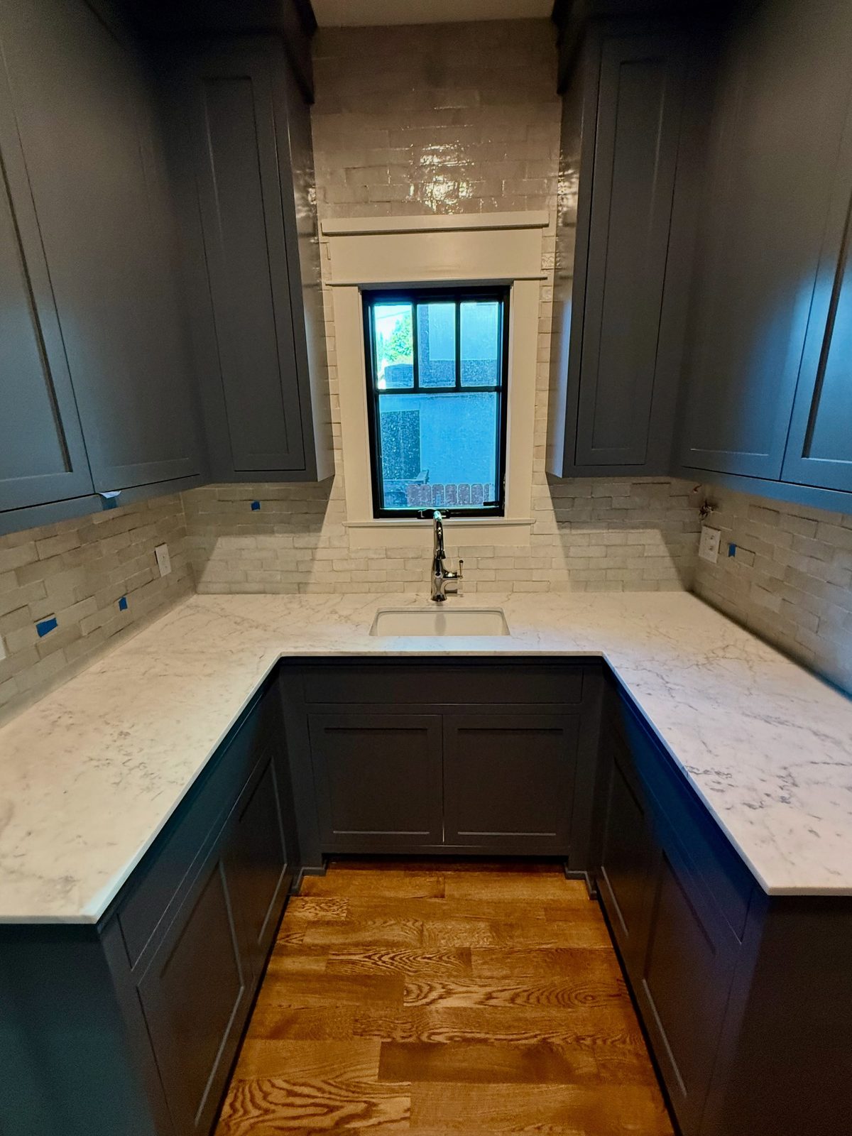 Butler's pantry with island and range hood
