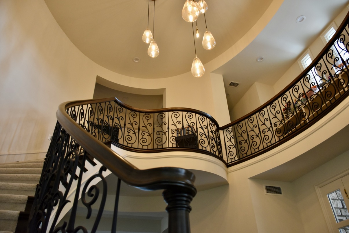 Curved staircase with wrought iron railing