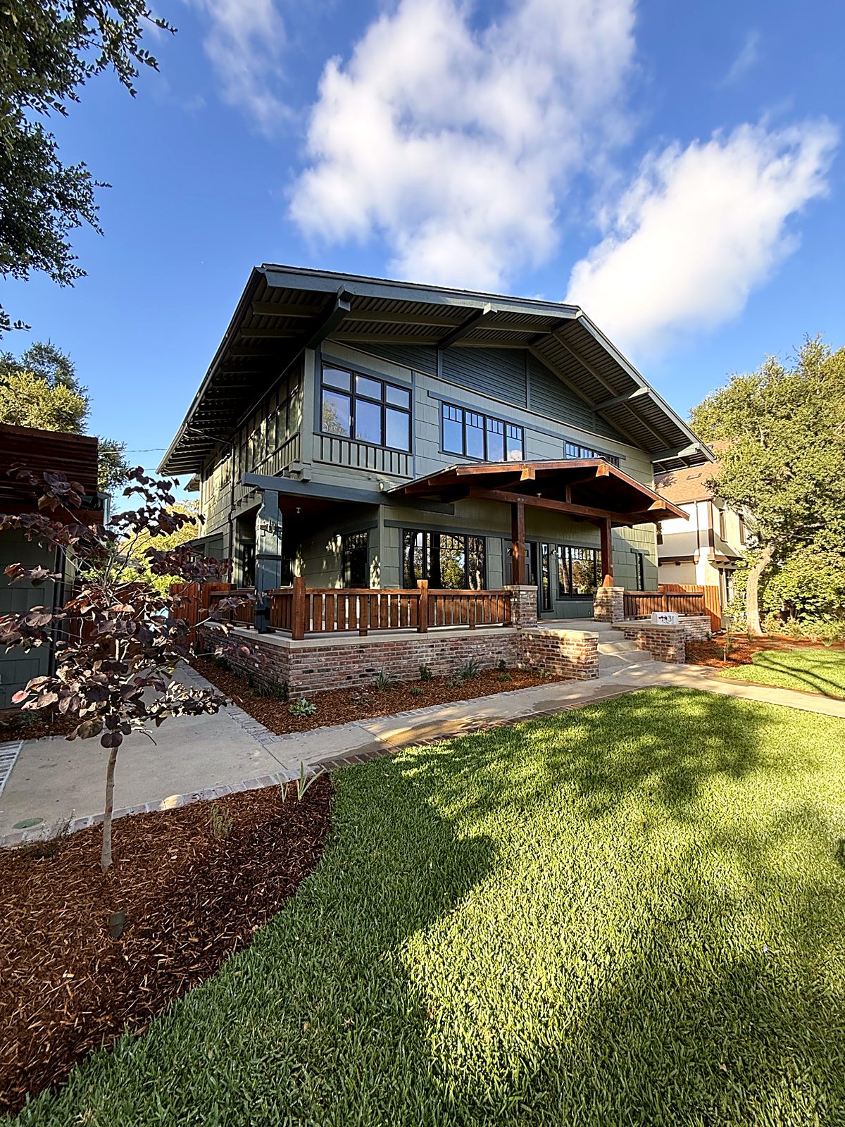 Finished craftsman house with rebuilt brick and timber porch